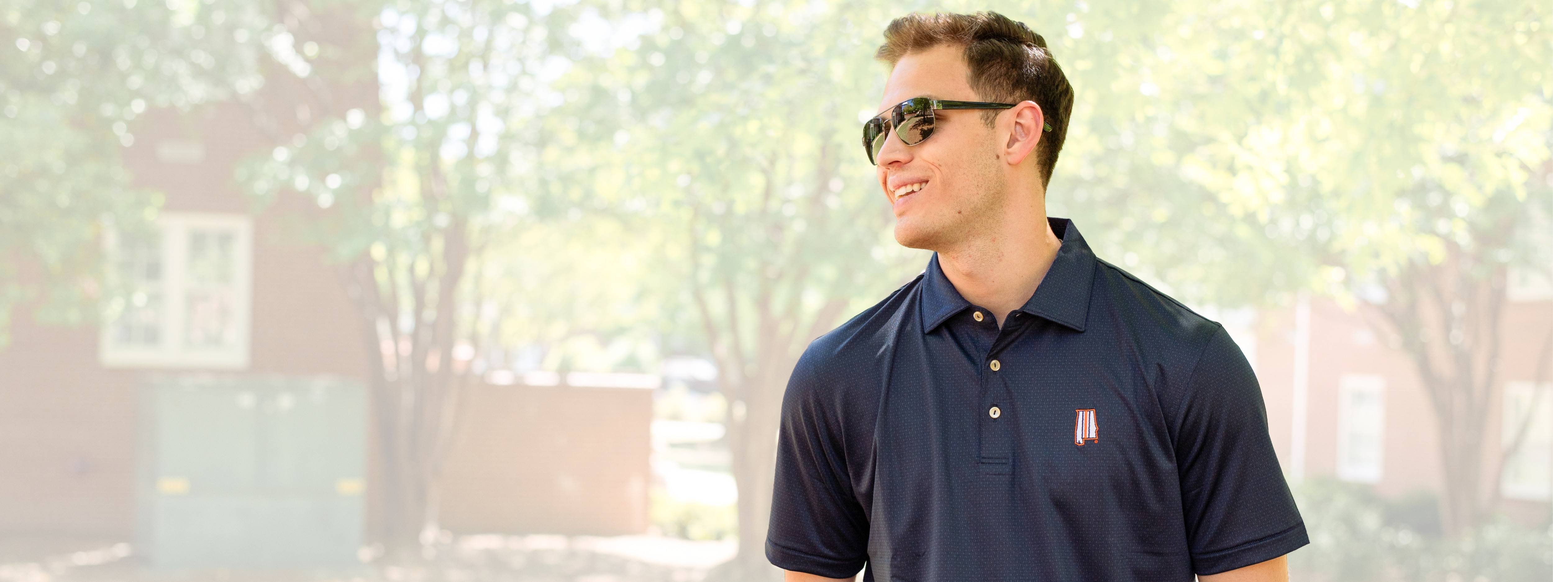 Auburn student wearing an Auburn navy polo